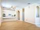 Bright living room featuring wood floors, neutral paint, arched openings, and a ceiling fan at 14228 Portrush Dr, Orlando, FL 32828