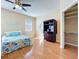 Spacious main bedroom with ceiling fan, hardwood floors, closet, and ample sunlight at 14228 Portrush Dr, Orlando, FL 32828