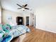 Relaxing main bedroom with hardwood floors, ceiling fan, and view of closet and hallway at 14228 Portrush Dr, Orlando, FL 32828