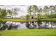 Scenic pond reflecting lush greenery and RV park, creating a tranquil outdoor setting at 14228 Portrush Dr, Orlando, FL 32828