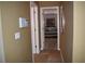 Hallway leading to a carpeted bedroom with decorative headboard and natural light at 1457 Waukon Cir, Casselberry, FL 32707