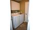 Bright laundry room with white cabinets, washer, and dryer with tile flooring at 1457 Waukon Cir, Casselberry, FL 32707