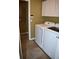 Bright laundry room with white cabinets, washer, and dryer with tile flooring at 1457 Waukon Cir, Casselberry, FL 32707