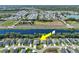 Drone shot of home near tranquil river showing proximity to community amenities and well-planned neighborhood at 149 St Thomas Dr, Mulberry, FL 33860