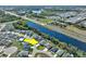 Aerial view of a community showcasing a neighborhood near a pond, a highway, and mature trees at 149 St Thomas Dr, Mulberry, FL 33860