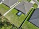 Aerial view of a fenced backyard featuring a screened-in hot tub and ample green space at 149 St Thomas Dr, Mulberry, FL 33860