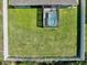 Aerial shot of a fenced backyard with a screened-in hot tub, offering privacy and outdoor enjoyment at 149 St Thomas Dr, Mulberry, FL 33860