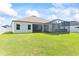 Spacious backyard, featuring a screened-in lanai and a lush lawn at 149 St Thomas Dr, Mulberry, FL 33860