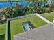 Aerial view of a fenced backyard with a screened hot tub and well-manicured lawn at 149 St Thomas Dr, Mulberry, FL 33860