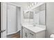 Bright bathroom with a large mirror, white vanity, and modern fixtures at 149 St Thomas Dr, Mulberry, FL 33860
