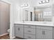 Bathroom with double sink vanity, granite countertops, and a glass enclosed shower at 149 St Thomas Dr, Mulberry, FL 33860