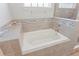 Bathroom showing large soaking tub surrounded by tile with a glass enclosed shower at 149 St Thomas Dr, Mulberry, FL 33860