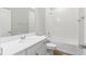 Bright bathroom featuring a modern vanity, toilet, and tiled shower-tub combo at 149 St Thomas Dr, Mulberry, FL 33860