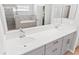 Bathroom featuring double sink vanity, soaking tub, and tiled walk-in shower at 149 St Thomas Dr, Mulberry, FL 33860