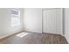 Bright bedroom with hardwood floors, closet with white doors, and natural light at 149 St Thomas Dr, Mulberry, FL 33860