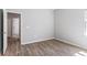 Neutral bedroom featuring modern hardwood floors, a standard closet, and natural light at 149 St Thomas Dr, Mulberry, FL 33860