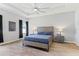 Serene bedroom with wood-look flooring, stylish furnishings, and natural light from the window at 149 St Thomas Dr, Mulberry, FL 33860