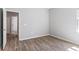 Neutral bedroom with light gray walls, modern floors and a doorway with a view into the adjacent bathroom at 149 St Thomas Dr, Mulberry, FL 33860