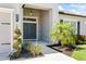 Elegant double front door with sidelights, decorative plants and rock garden at 149 St Thomas Dr, Mulberry, FL 33860