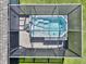 Close-up aerial view of a screened-in hot tub with steps, providing a relaxing retreat in the backyard at 149 St Thomas Dr, Mulberry, FL 33860