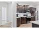 Modern kitchen featuring stainless steel appliances and dark cabinets, creating a cozy atmosphere at 149 St Thomas Dr, Mulberry, FL 33860