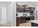 Modern kitchen with stainless steel appliances, dark cabinets, and white countertops at 149 St Thomas Dr, Mulberry, FL 33860