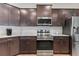 Well-equipped kitchen with stainless steel appliances and dark wood cabinetry at 149 St Thomas Dr, Mulberry, FL 33860