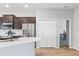 Kitchen featuring stainless steel appliances, dark cabinets, light countertop, and adjacent dining area at 149 St Thomas Dr, Mulberry, FL 33860