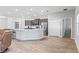 Open-concept kitchen boasts stainless steel appliances, a large island, and dark wood cabinets, seamlessly connecting living areas at 149 St Thomas Dr, Mulberry, FL 33860