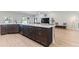 Spacious kitchen island features bar seating, dark wood cabinetry, and quartz countertops at 149 St Thomas Dr, Mulberry, FL 33860