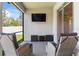 Screened lanai features outdoor seating and a wall-mounted TV at 149 St Thomas Dr, Mulberry, FL 33860