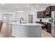 Open-concept living area featuring a large kitchen island and stainless steel appliances, promoting a modern and airy feel at 149 St Thomas Dr, Mulberry, FL 33860