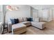 Bright living room with a comfortable gray couch and modern lighting fixture at 149 St Thomas Dr, Mulberry, FL 33860