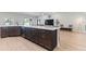 A modern living room features a large kitchen island and comfortable living area with natural light at 149 St Thomas Dr, Mulberry, FL 33860