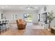 Bright living room with two brown lounge chairs and view of a fenced backyard at 149 St Thomas Dr, Mulberry, FL 33860