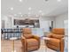 Spacious living area has wood floors, neutral tones and two leather armchairs that create a cozy, welcoming space at 149 St Thomas Dr, Mulberry, FL 33860
