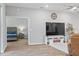 Stylish living room featuring a large television and view into the bedroom at 149 St Thomas Dr, Mulberry, FL 33860