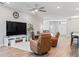Bright living room offering a comfortable seating area and kitchen view in an open concept floor plan at 149 St Thomas Dr, Mulberry, FL 33860