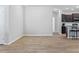 Open-concept living space with wood-look floors, leading to a modern kitchen at 149 St Thomas Dr, Mulberry, FL 33860