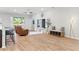 Spacious living room with wood floors, two leather chairs, ceiling fan, and access to the backyard at 149 St Thomas Dr, Mulberry, FL 33860