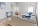 Living room with modern decor, wood floors, and a gray sofa with blue pillows at 149 St Thomas Dr, Mulberry, FL 33860