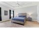 Spacious main bedroom with tray ceilings, ceiling fan and stylish wood accents at 149 St Thomas Dr, Mulberry, FL 33860