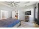 This is a spacious main bedroom with wood floors, fan, and a chest of drawers at 149 St Thomas Dr, Mulberry, FL 33860