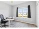 Home office with a large window, wood-look floors, and an adjustable desk at 149 St Thomas Dr, Mulberry, FL 33860