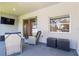 Outdoor patio features sliding glass doors, television, and wicker furniture at 149 St Thomas Dr, Mulberry, FL 33860