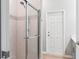 Shower stall featuring glass door, tiled walls with decorative strip, and chrome fixtures at 149 St Thomas Dr, Mulberry, FL 33860