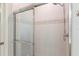 Close-up of the shower, features glass doors and tiled walls, providing a clean and modern design at 149 St Thomas Dr, Mulberry, FL 33860