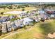 Aerial view of the community with homes, golf course and mature landscaping at 1523 Corolla Ct, Reunion, FL 34747