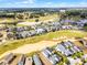 Community aerial view showcasing golf course, water features, and residential homes at 1523 Corolla Ct, Reunion, FL 34747