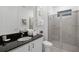 Bright bathroom with a sleek vanity, granite countertop, and glass-enclosed shower at 1523 Corolla Ct, Reunion, FL 34747